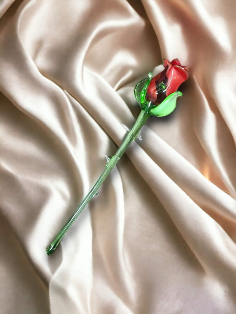 a single rose on a white satin background