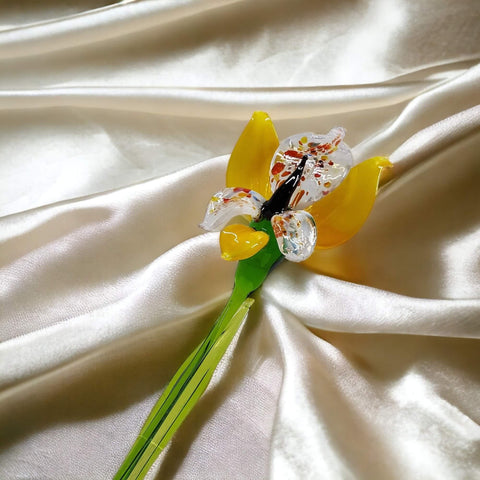 a yellow flower on a white fabric