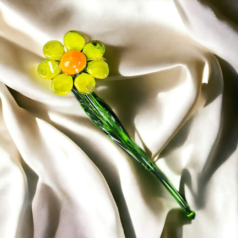 a yellow and green flower on a white cloth