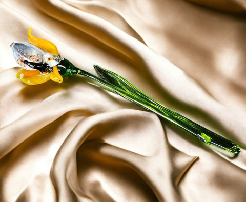 a single yellow flower on a white cloth