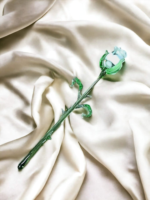 a flower that is laying on a white cloth