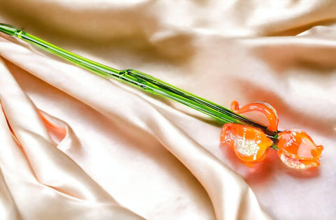 a close up of a flower on a white cloth