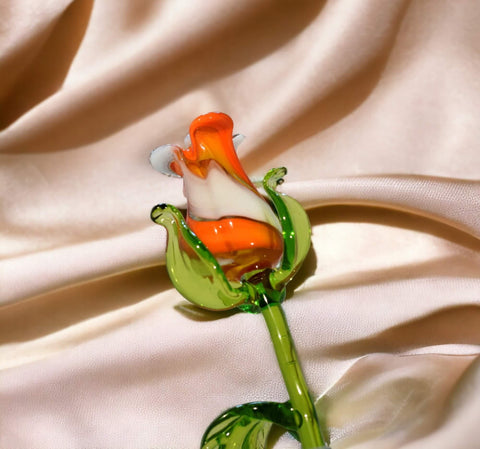 a small glass flower on a white cloth