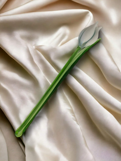 a white sheet with a green stem on it