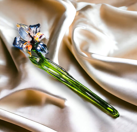 a glass flower on a satin fabric