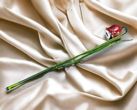 a flower laying on top of a white cloth