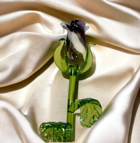 a green glass flower on a white cloth