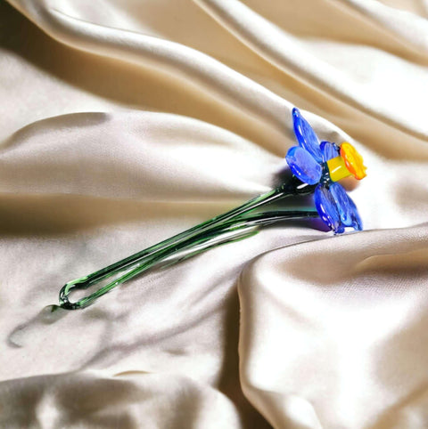 a bouquet of flowers sitting on top of a white cloth