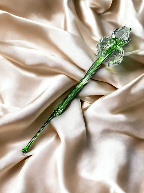 a green flower laying on top of a white cloth