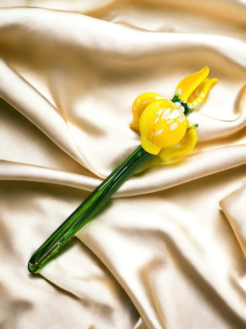 a single yellow flower on a white cloth