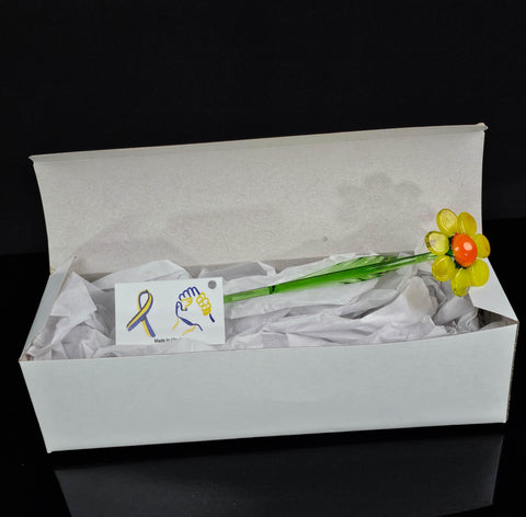 a white box with a yellow flower in it