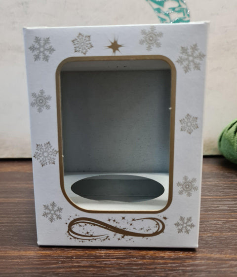 a small white box with a snowflake design on it