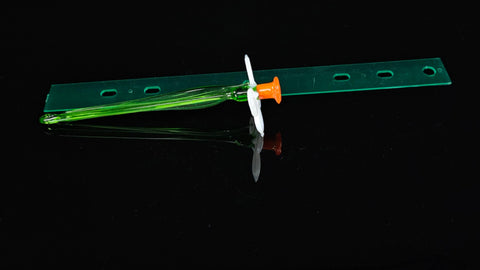 a toothbrush sitting on top of a green piece of plastic