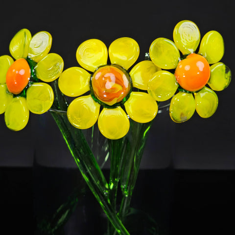 a vase filled with yellow flowers on top of a table