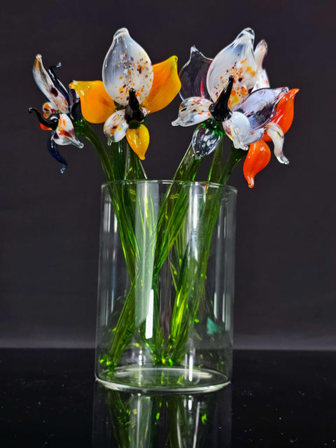 a glass vase filled with flowers on top of a table