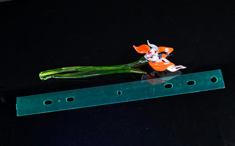 a plastic figurine is sitting on top of a piece of plastic