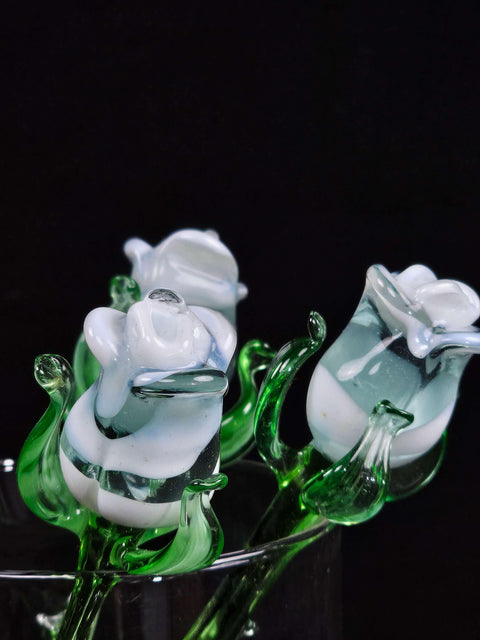 a glass vase filled with flowers on top of a table