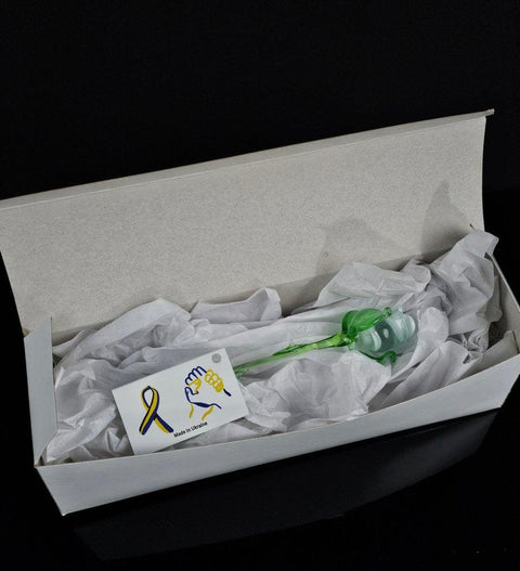 an open box with a green and yellow toothbrush in it