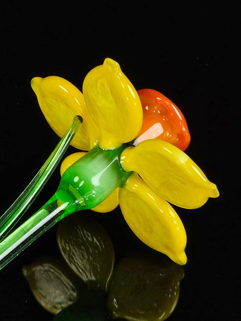 a flower made out of plastic sitting on a table