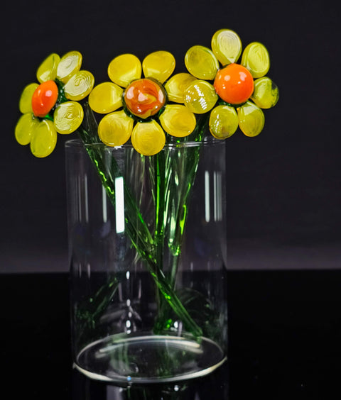 a glass vase filled with yellow and red flowers