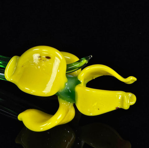 a yellow glass figurine sitting on top of a table