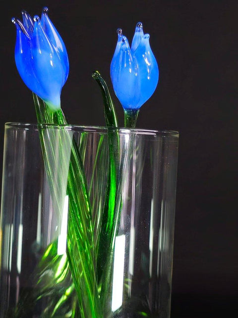 a close up of a vase with flowers in it