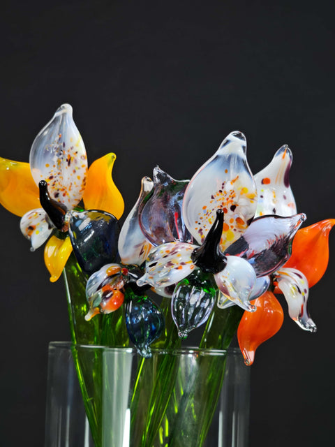 a glass vase filled with colorful glass flowers