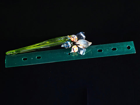 a green piece of plastic sitting on top of a black surface