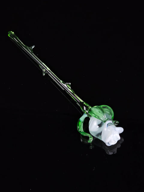 a glass pipe with a green flower on it