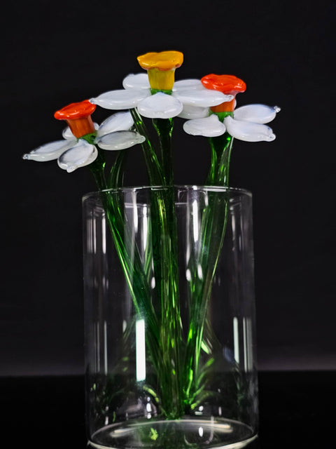 a glass vase filled with flowers on top of a table