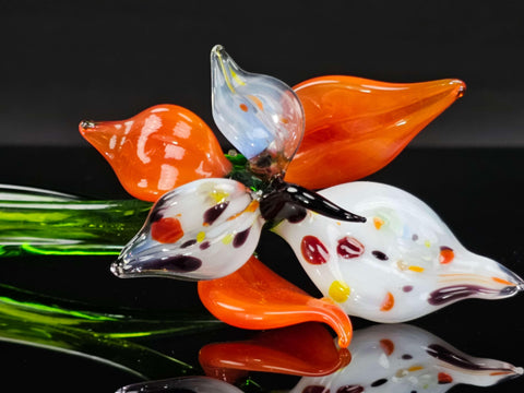 a close up of a glass flower on a table