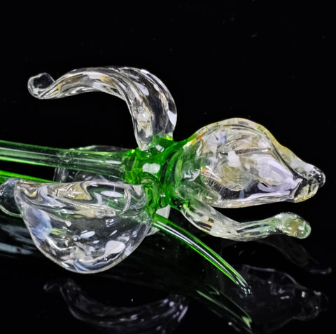 a glass figurine of a dog on a black background